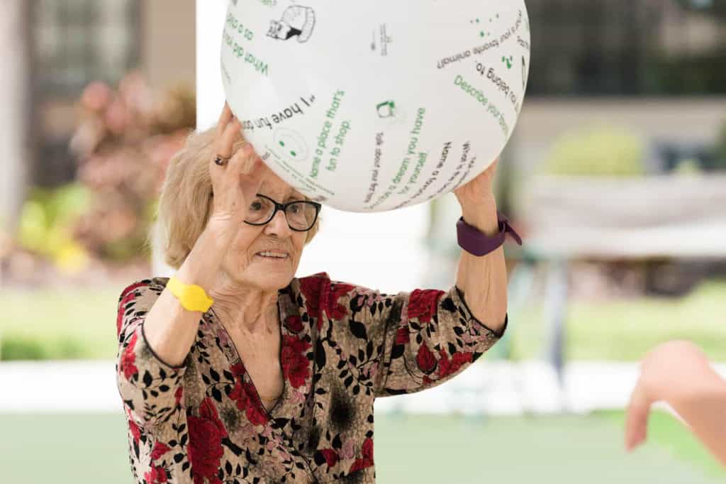 senior resident tossing a ball