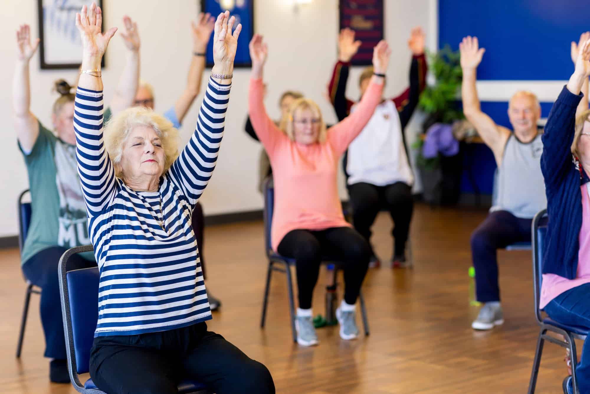 Senior Citizens exercising - chair aerobics