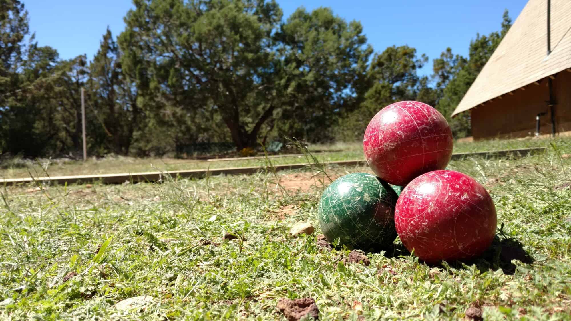 Stack of four bocce balls on the grass