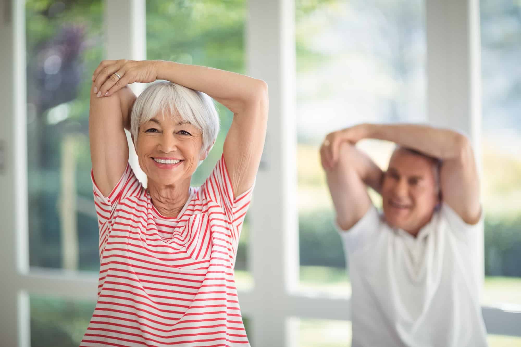 Two senior citizens stretching