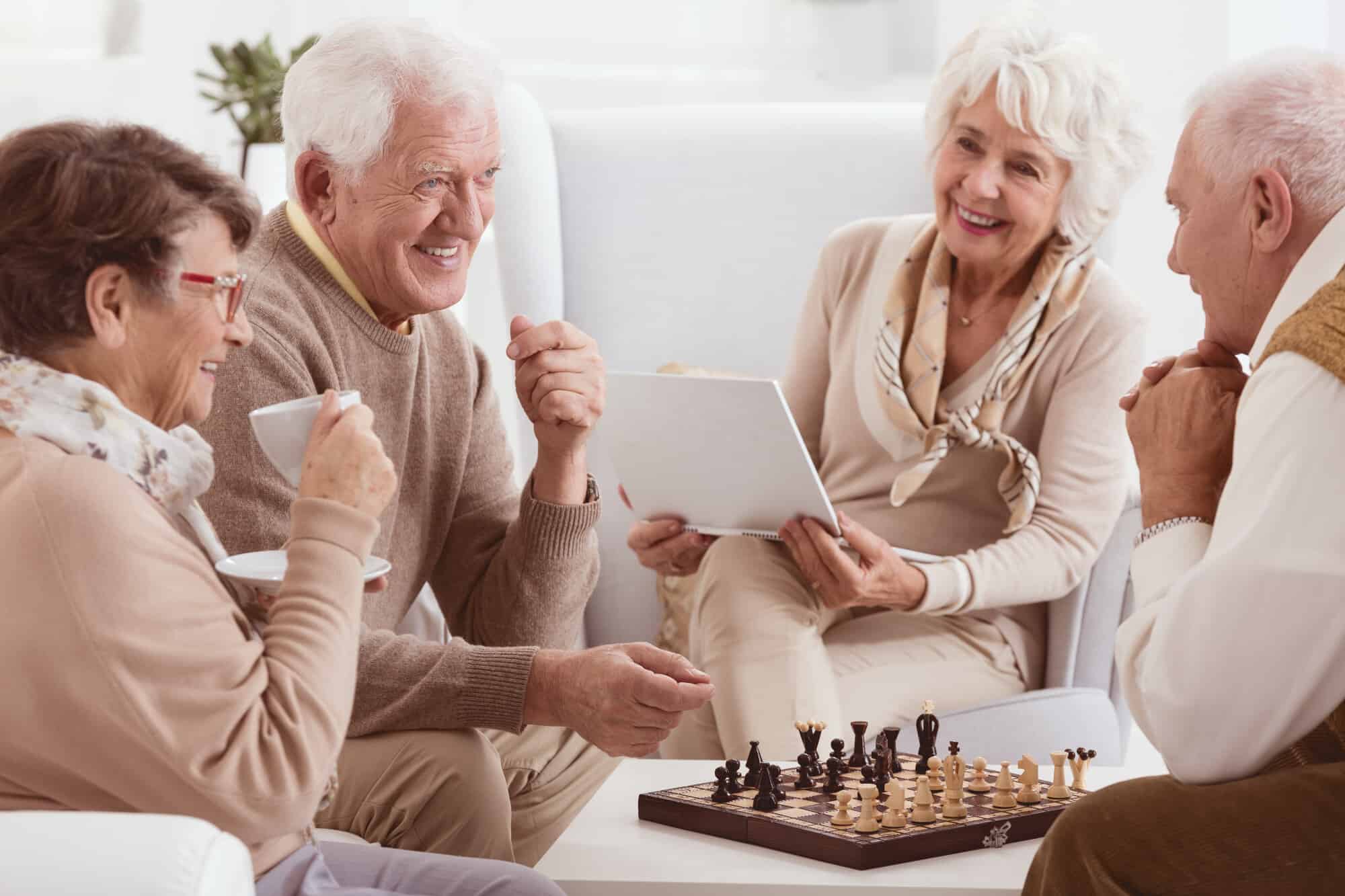 Group of senior citizens having fun and playing chess