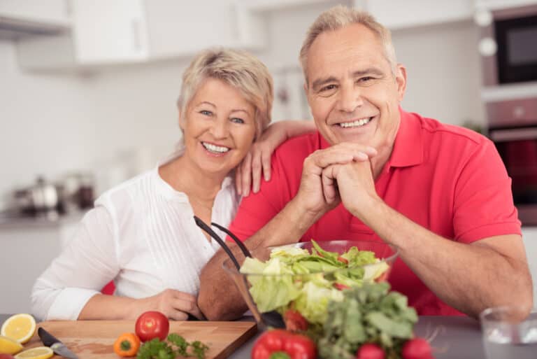 Smiling senior couple preparing healthy food