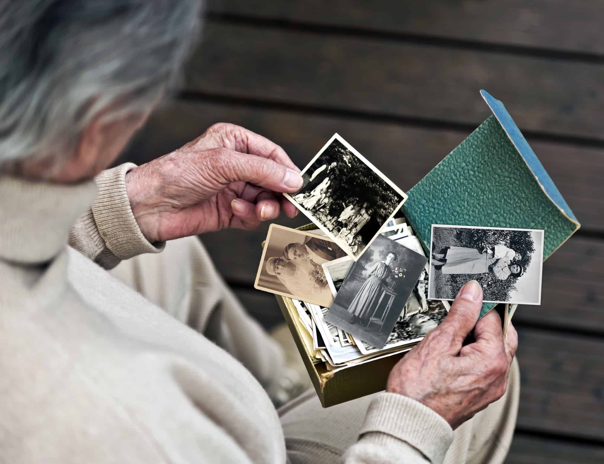 Elderly lady looking at old photos