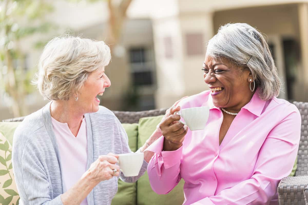 Senior Ladies laughing and drinking tea