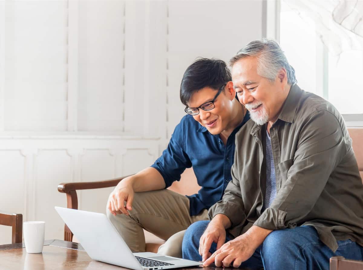 Adult son and Senior dad looking into senior living options