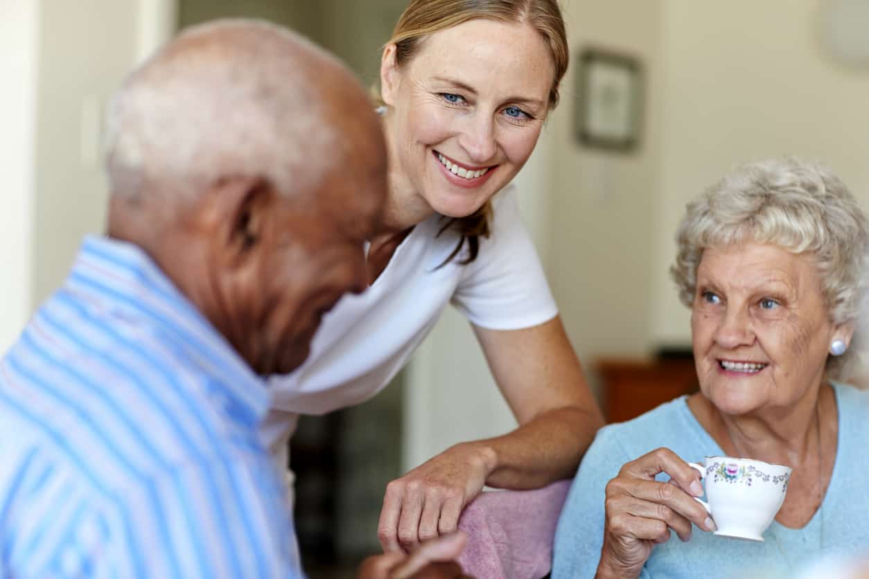 Caretaker with senior people in nursing home, Premier Dementia Care Apartments in Tampa, FL
